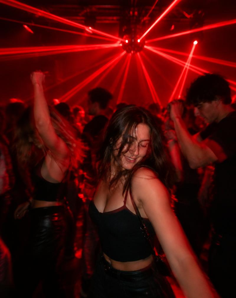 Students dancing under red lasers
